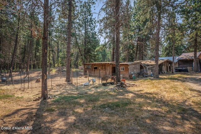 exterior space featuring an outdoor structure and fence