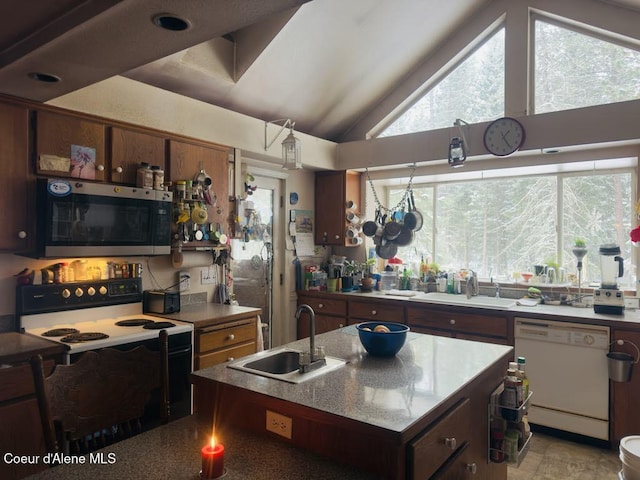 kitchen with stainless steel microwave, a sink, electric range oven, and white dishwasher