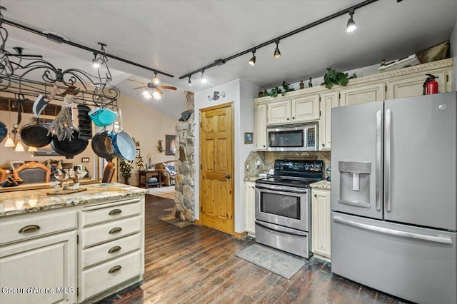 kitchen with light stone countertops, dark wood-style floors, ceiling fan, stainless steel appliances, and backsplash