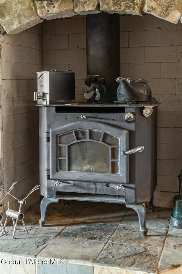 details with concrete block wall and a wood stove