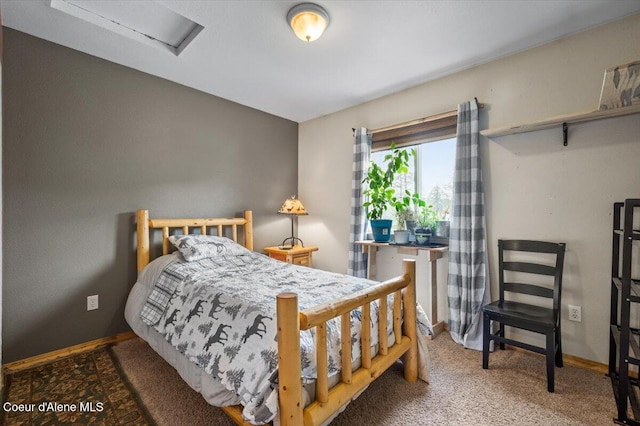 carpeted bedroom with attic access and baseboards