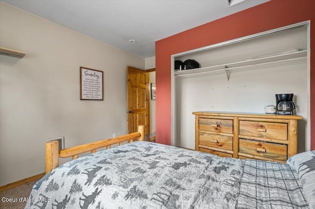 bedroom with a closet and baseboards