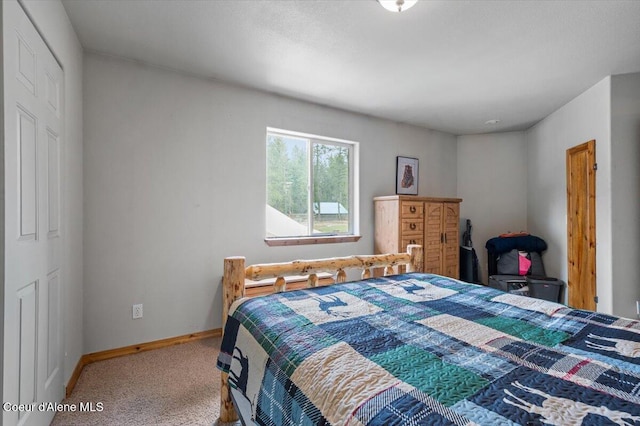 bedroom with baseboards and carpet