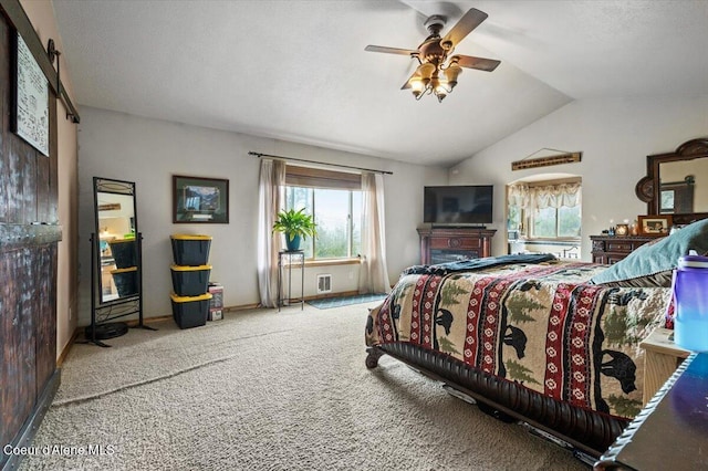 carpeted bedroom featuring lofted ceiling and a ceiling fan