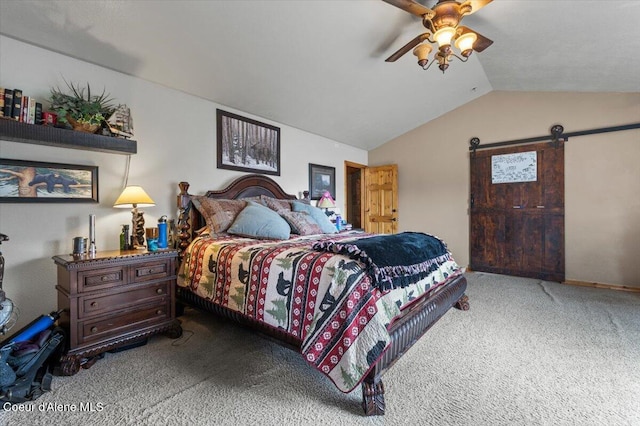 bedroom with ceiling fan, a barn door, carpet, and vaulted ceiling