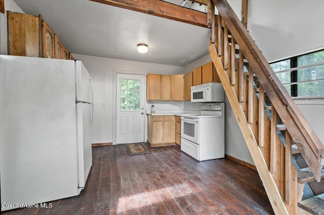 kitchen featuring dark wood-style floors, white appliances, light countertops, and baseboards