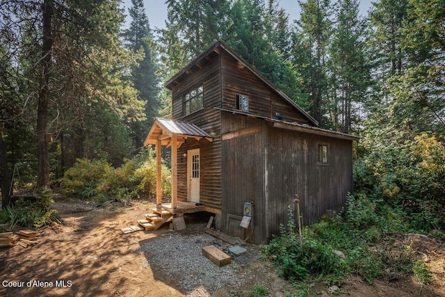 view of outdoor structure with a view of trees