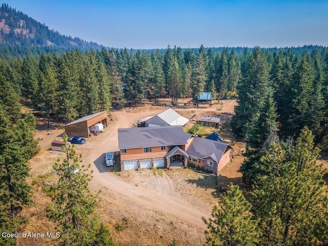 drone / aerial view featuring a view of trees