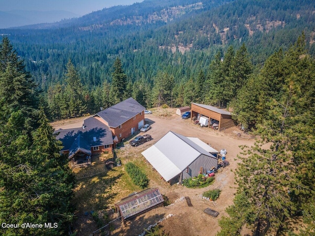 birds eye view of property with a wooded view