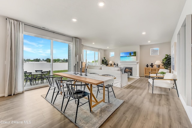355 E Burdock Loop, Hayden, ID 83835 - dining room featuring a glass covered fireplace, recessed lighting, light wood-type flooring, and baseboards