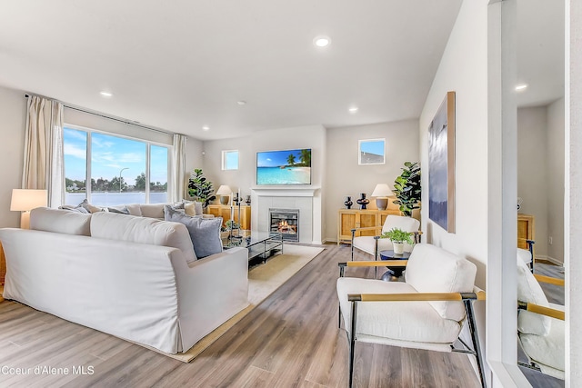 355 E Burdock Loop, Hayden, ID 83835 - living area with a tiled fireplace, recessed lighting, wood finished floors, and baseboards