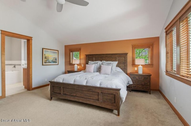 carpeted bedroom with ceiling fan, baseboards, lofted ceiling, and ensuite bath