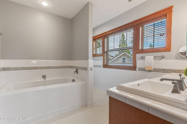 full bath featuring vanity, a garden tub, and tile patterned floors