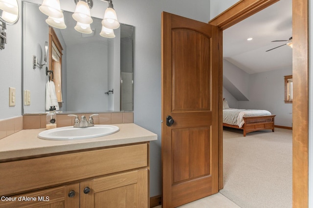 bathroom featuring ensuite bathroom, a ceiling fan, and vanity