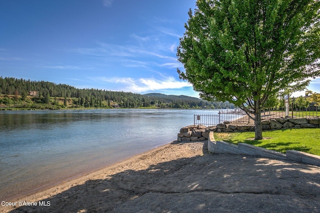 view of water feature with a forest view