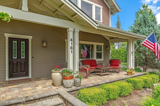 property entrance with a porch and an outdoor living space