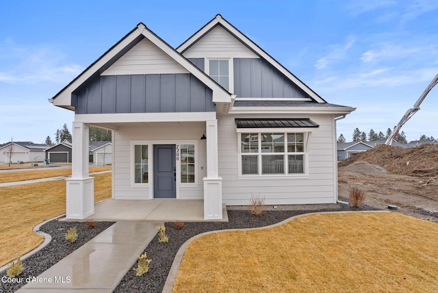 view of front of house with a front lawn and board and batten siding