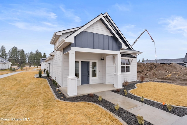 modern farmhouse featuring board and batten siding and a front yard