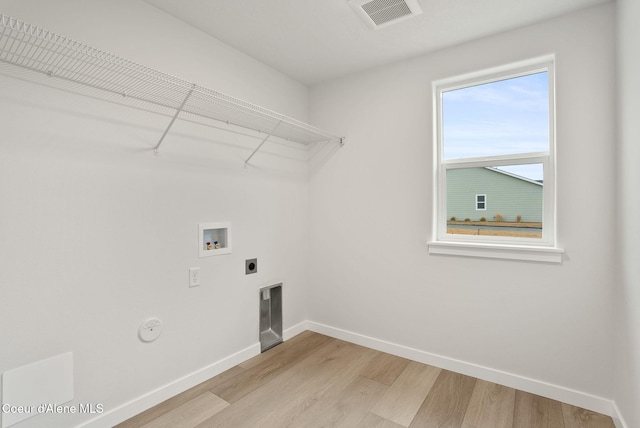 laundry room with light wood-type flooring, visible vents, washer hookup, baseboards, and laundry area