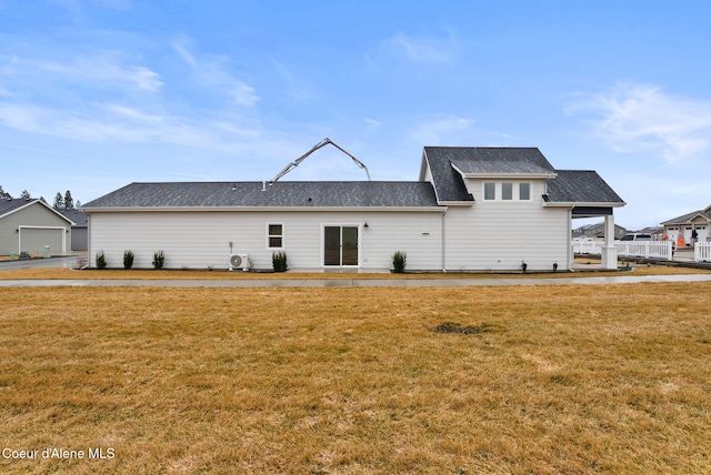 rear view of property featuring a yard