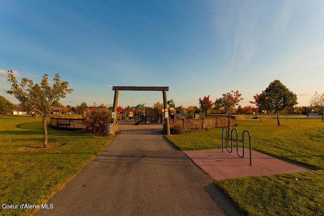 view of community with playground community and a yard