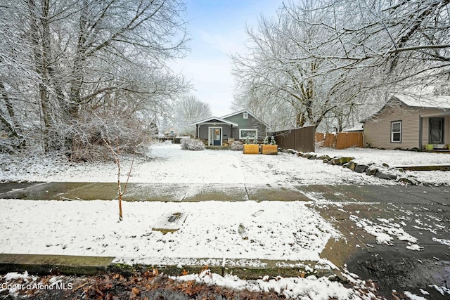 yard covered in snow with fence