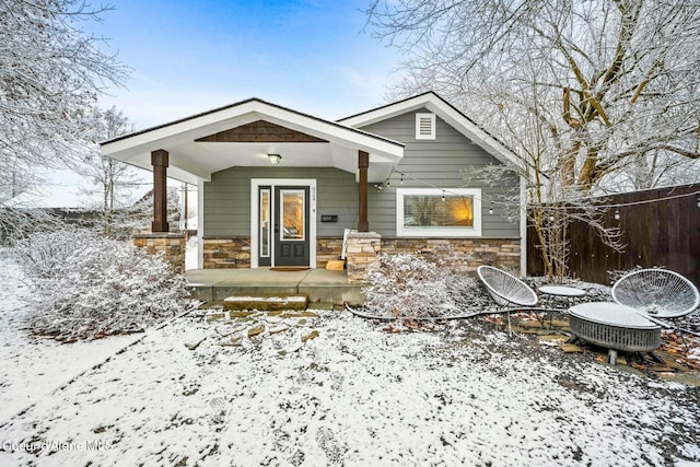 bungalow-style house with stone siding