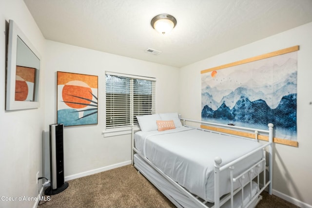 carpeted bedroom with visible vents and baseboards