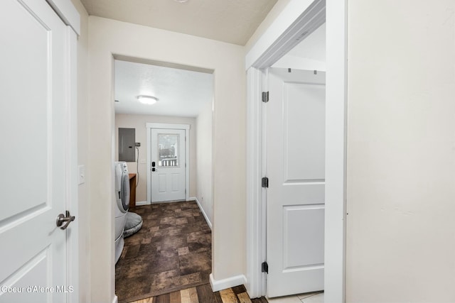 washroom with electric panel, baseboards, and laundry area