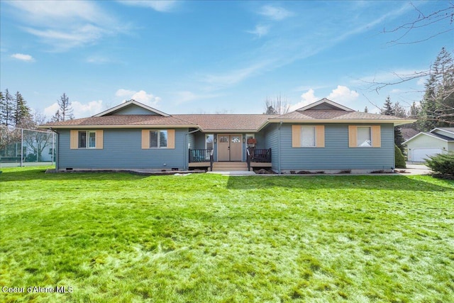 back of house with crawl space and a yard