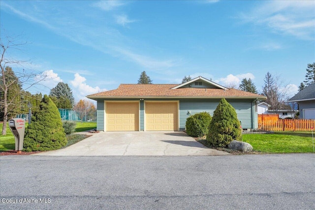 ranch-style house featuring concrete driveway, a garage, fence, and a front yard