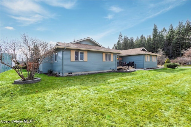 rear view of house featuring a yard