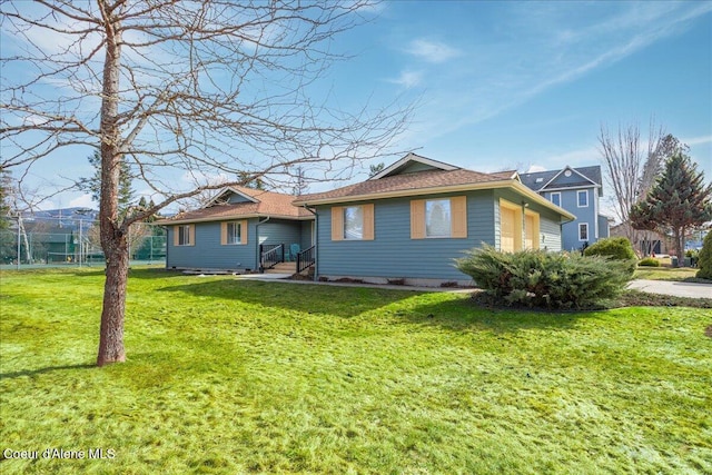 back of house with an attached garage, a yard, and fence