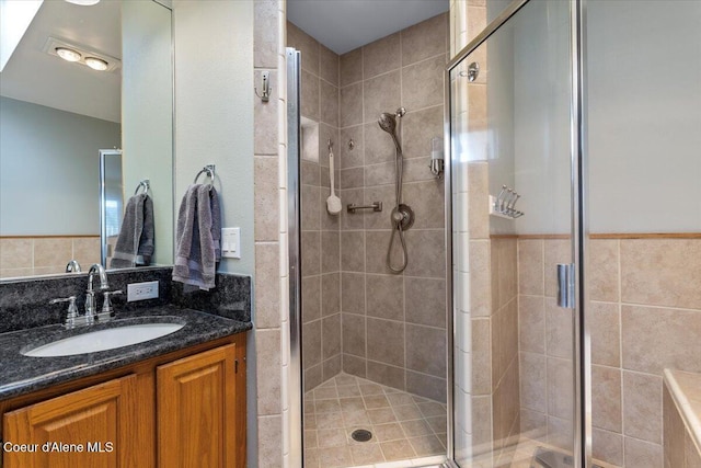 full bath with vanity and a stall shower