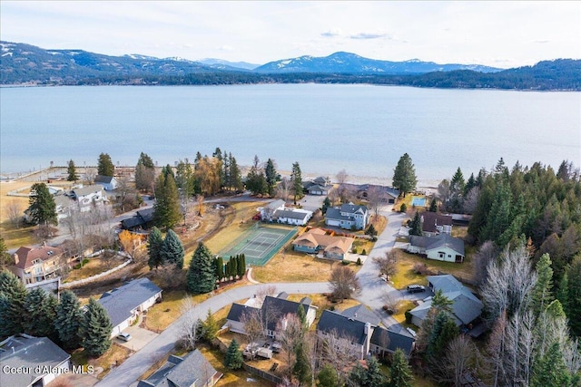 birds eye view of property with a water and mountain view