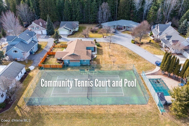 drone / aerial view featuring a residential view and a view of trees