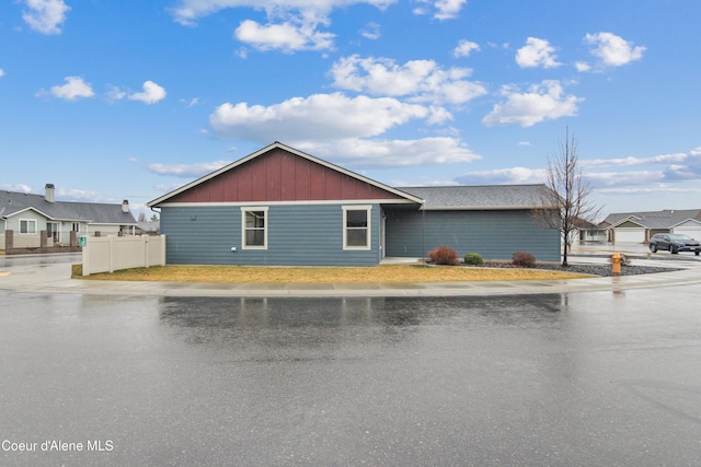 view of front of house with fence and board and batten siding