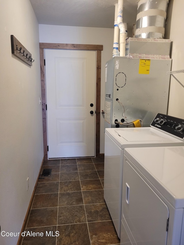 laundry area featuring washer and dryer, visible vents, baseboards, and laundry area