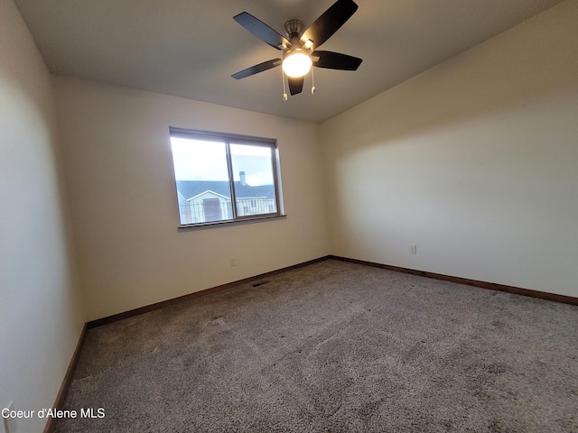 carpeted spare room with baseboards and ceiling fan