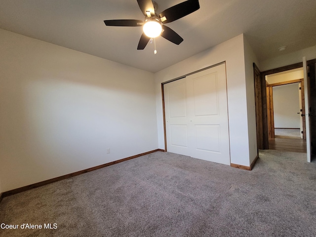 unfurnished bedroom featuring a closet, baseboards, carpet, and ceiling fan