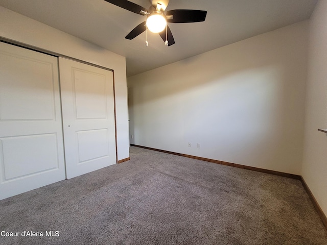 unfurnished bedroom with a closet, carpet flooring, ceiling fan, and baseboards