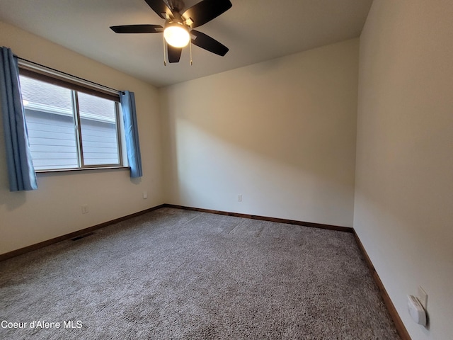 empty room with visible vents, baseboards, ceiling fan, and carpet flooring