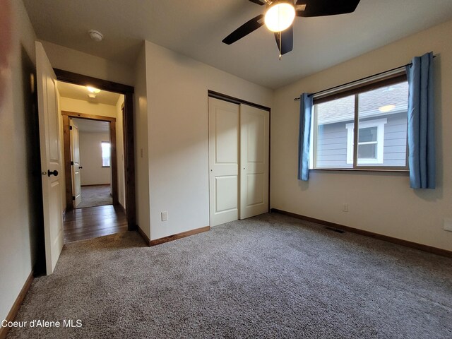 unfurnished bedroom featuring visible vents, baseboards, ceiling fan, carpet flooring, and a closet