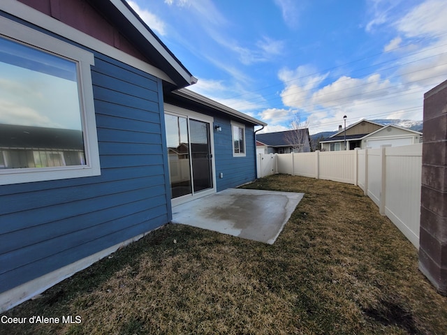 view of yard with a fenced backyard and a patio