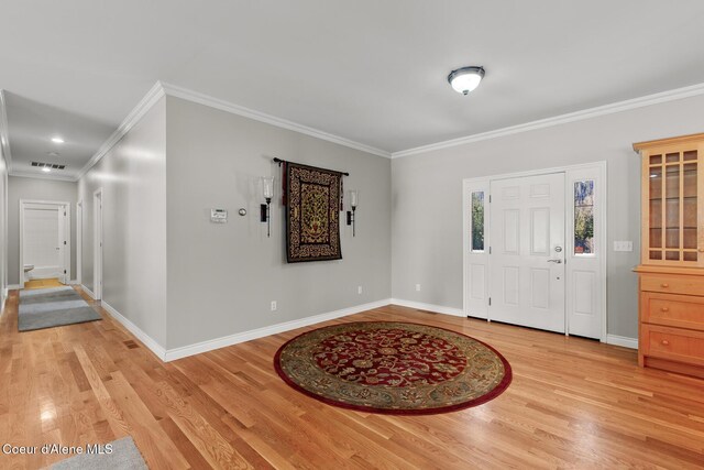 foyer with visible vents, baseboards, and light wood-style floors