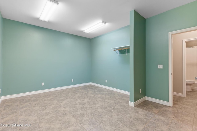 empty room featuring baseboards