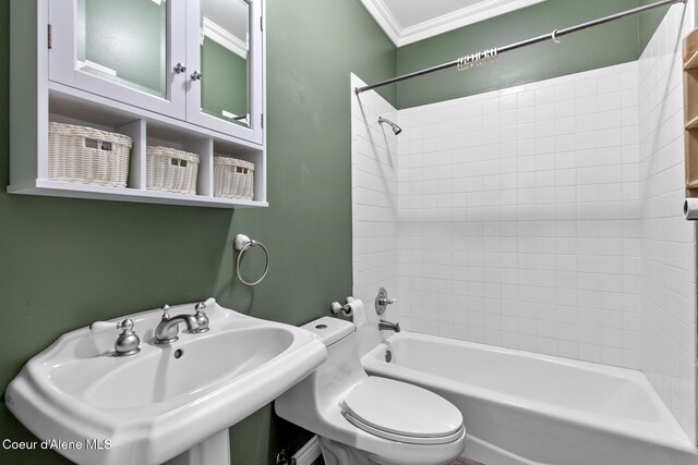 full bathroom with crown molding, shower / bath combination, toilet, and a sink