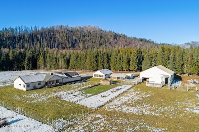 birds eye view of property featuring a wooded view