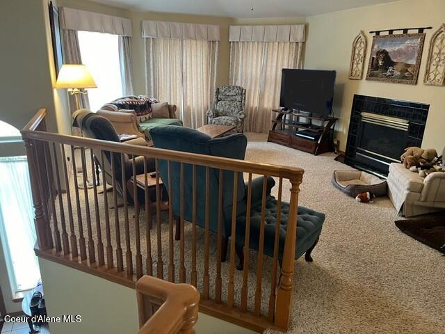 living room featuring carpet floors and a fireplace