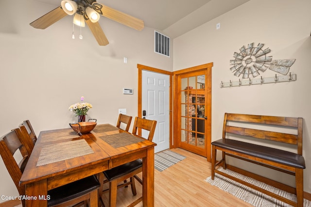dining area with light wood-style flooring, visible vents, and ceiling fan